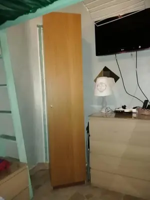 a room with a wooden cabinet and a tv on the wall at Lockable room center in Antwerp