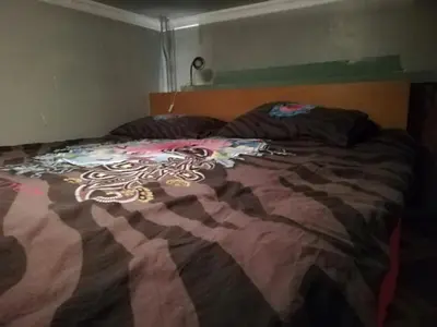 a bed with a colorful blanket on top of it at Lockable room center in Antwerp