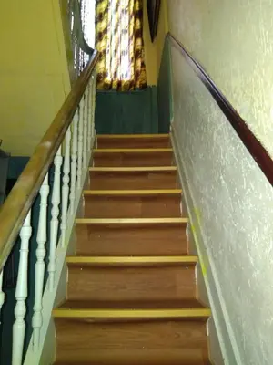 a flight of stairs in a church with a stained glass window at Lockable room center in Antwerp