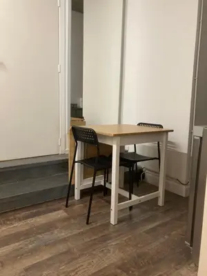 a table and two chairs in a room at Quest house in the city in Ghent