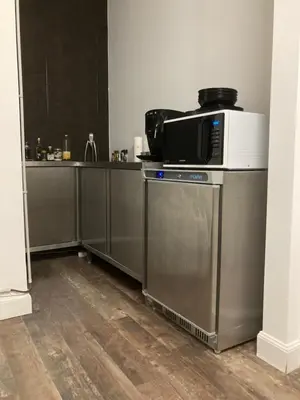 a kitchen with a microwave on top of a dishwasher at Quest house in the city in Ghent