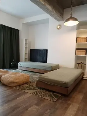 a bedroom with two beds and a rug at Quest house in the city in Ghent