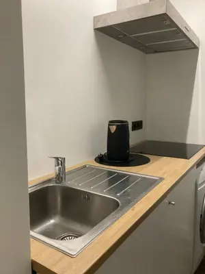 a kitchen with a stainless steel sink in a kitchen at Quest house in the city in Ghent