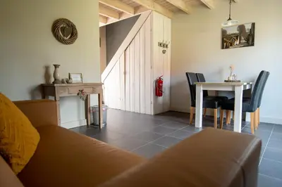 a living room with a couch and a table at Bed and Breakfast Paellepelhoeve in Ninove