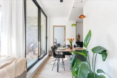 a dining room with a table and some plants at Sunny haven in Antwerp