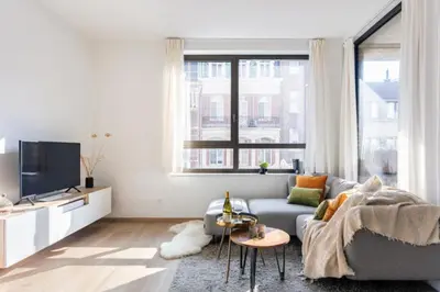 a living room with a couch and a tv at Sunny haven in Antwerp