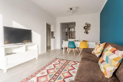 a living room with a couch and a flat screen tv at Center of Antwerp, Fully Equipped, Train Station in Antwerp