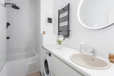 a white bathroom with a sink and a mirror at Center of Antwerp, Fully Equipped, Train Station in Antwerp