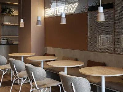 a row of tables and chairs in a restaurant at Adagio Access Gent Centrum Dampoort in Ghent