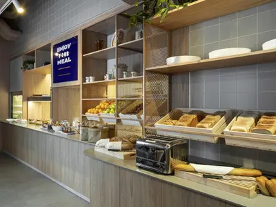 a bakery with lots of bread and other foods on display at Adagio Access Gent Centrum Dampoort in Ghent