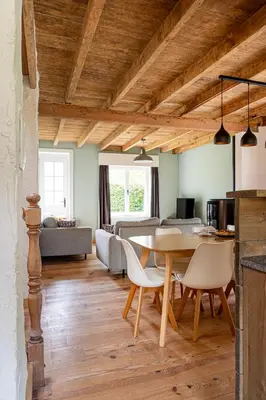 a kitchen and living room with a table and chairs at 't Jongehof in Zaffelare