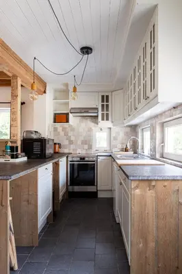 a kitchen with white cabinets and a stove top oven at 't Jongehof in Zaffelare