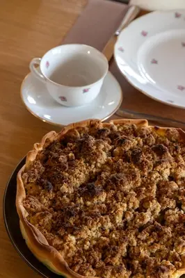 a pie sitting on a table with a cup of coffee at 't Jongehof in Zaffelare