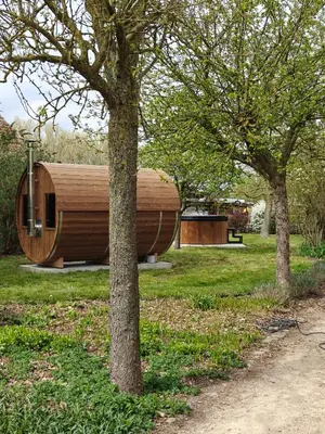 a wooden building in a park with trees at 't Jongehof in Zaffelare