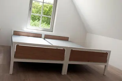 a bed in a room with a window at Kasteel Boterlaerhof Antwerpen in Antwerp