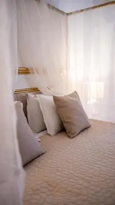 a group of pillows sitting on top of a bed at Hotel de Maître de Vaughan in Brussels