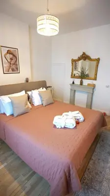 a bedroom with a large bed with towels on it at Hotel de Maître de Vaughan in Brussels