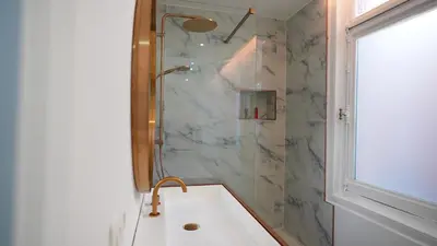 a bathroom with a shower and a tub with a sink at Hotel de Maître de Vaughan in Brussels