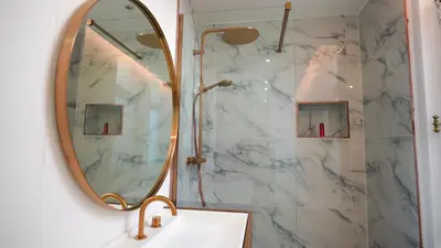 a bathroom with a shower and a sink and a mirror at Hotel de Maître de Vaughan in Brussels
