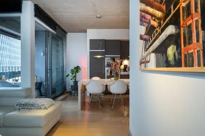 a living room with a couch and a table at London 993 Loft 402 in Antwerp