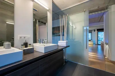 a bathroom with two sinks and a large mirror at London 993 Loft 402 in Antwerp