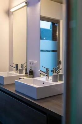 a bathroom with two sinks and a large mirror at London 993 Loft 402 in Antwerp