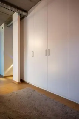 a room with white cabinets and a rug at London 993 Loft 402 in Antwerp