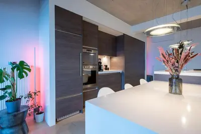 a kitchen with a white table and some plants at London 993 Loft 402 in Antwerp