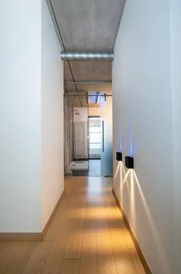 a hallway with white walls and a wooden floor at London 993 Loft 402 in Antwerp