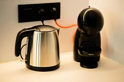 a coffee maker and a tea kettle on a counter at Luxury Suites Princess by Rikas Hotels in Antwerp