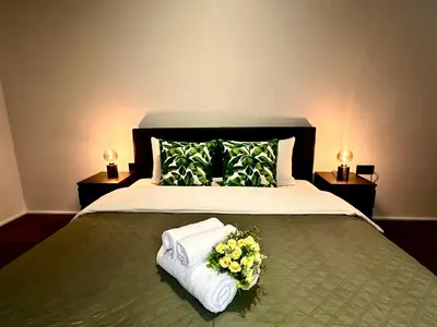 a bedroom with a bed with towels and flowers on it at Luxury Suites Princess by Rikas Hotels in Antwerp
