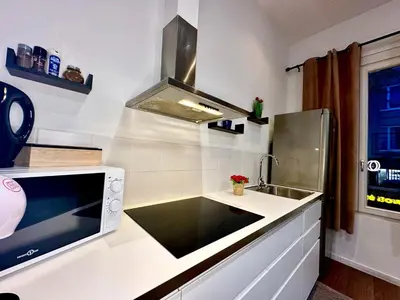 a white kitchen with a sink and a stove at Luxury Suites Centrum by Rikas Hotels in Antwerp