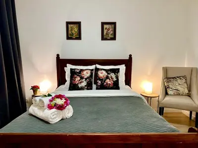 a bedroom with a bed with two flowers on it at Luxury Suites Centrum by Rikas Hotels in Antwerp