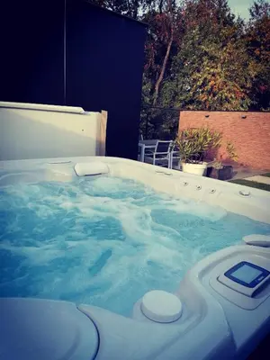 a jacuzzi tub with a cell phone in it at Vakantievilla met jacuzzi Limburg in Kwaadmechelen