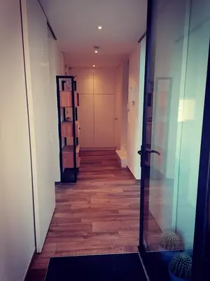 a hallway with a long corridor with wooden floors at Vakantievilla met jacuzzi Limburg in Kwaadmechelen