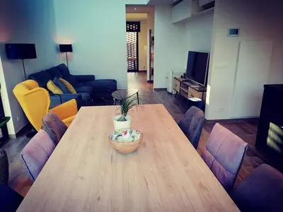 a living room with a wooden table with a bowl on it at Vakantievilla met jacuzzi Limburg in Kwaadmechelen