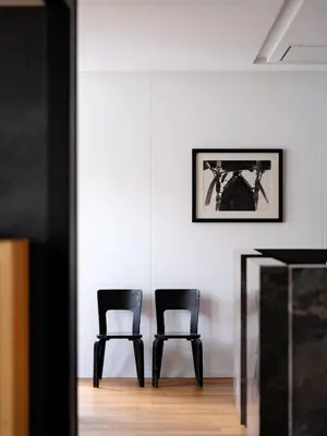 two black chairs sitting next to a table in a room at CE RESIDENCE in Ghent