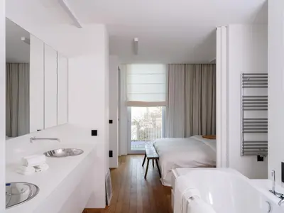 a white bathroom with two sinks and a bed at CE RESIDENCE in Ghent