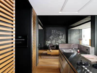 a kitchen with black cabinets and a sink at CE RESIDENCE in Ghent