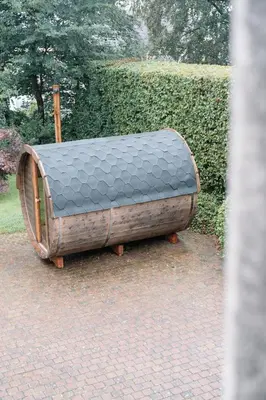 a wooden bed sitting on top of a brick ground at Chambres d'hôtes Eucalyptus et Glycine in Genval