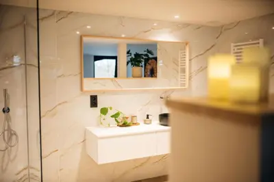 a bathroom with a white sink and a mirror at Chambres d'hôtes Eucalyptus et Glycine in Genval
