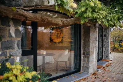 a glass window with a table in a building at Chambres d'hôtes Eucalyptus et Glycine in Genval
