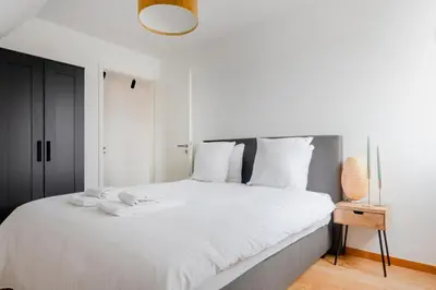 a bedroom with a large white bed with white pillows at Waterloo Design Residence in Waterloo