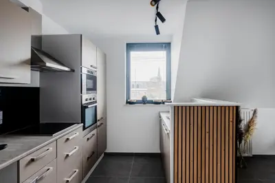 a kitchen with white cabinets and a window at Waterloo Design Residence in Waterloo