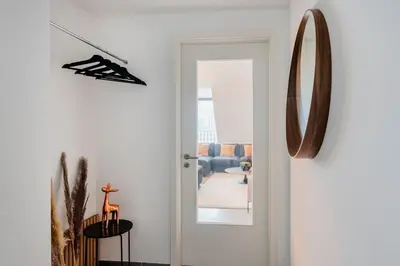 a hallway with a door leading to a living room at Waterloo Design Residence in Waterloo