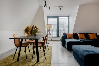 a living room with a table and a couch at Waterloo Design Residence in Waterloo