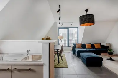 a kitchen and living room with a couch and a table at Waterloo Design Residence in Waterloo
