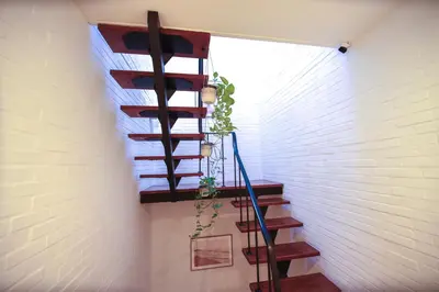 a spiral staircase in a room with a brick wall at Privé kamer met gedeelde badkamer - rand Antwerpen - afrit E313 Wommelgem in Antwerp