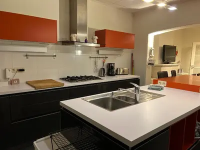 a kitchen with a sink and a stove at Les Cerises, charmante maison au calme in Wavre