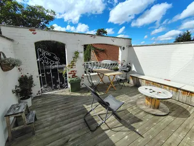 a patio with a table and a bench and a table at Cosy Apartment with Big Quiet & Sunny terras in Ghent